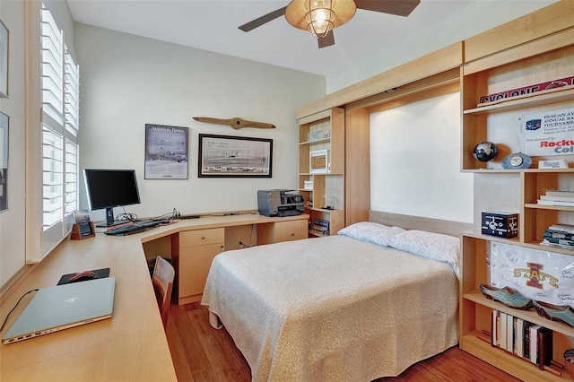 bedroom with ceiling fan and hardwood / wood-style floors