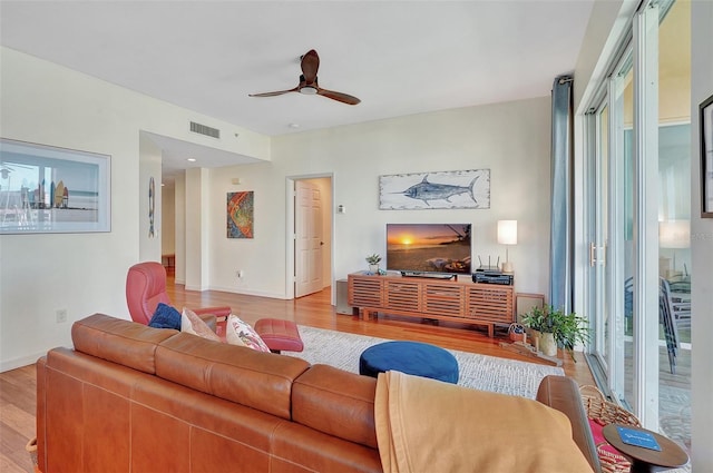 living room featuring ceiling fan and light wood-type flooring