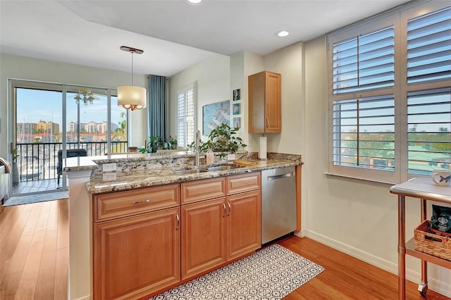 kitchen featuring kitchen peninsula, a healthy amount of sunlight, and sink