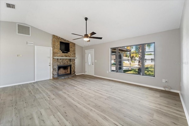 unfurnished living room with ceiling fan, light wood-type flooring, a fireplace, and vaulted ceiling