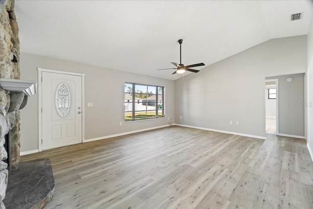 21047 Baffin Ave, Port Charlotte, FL 33954 - unfurnished living room with ceiling fan, a fireplace, light wood-type flooring, and lofted ceiling
