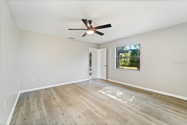 spare room with ceiling fan, light hardwood / wood-style floors, and a textured ceiling