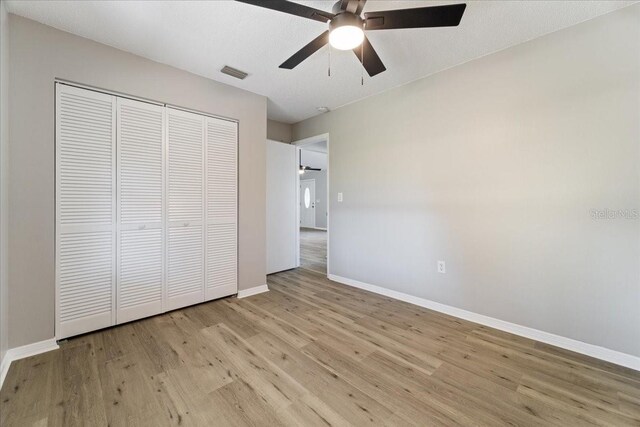 21047 Baffin Ave, Port Charlotte, FL 33954 - unfurnished bedroom featuring light wood-style flooring, a closet, and ceiling fan