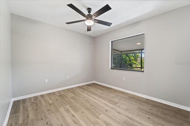 unfurnished room featuring ceiling fan, light hardwood / wood-style floors, and a textured ceiling