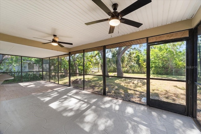 unfurnished sunroom featuring ceiling fan