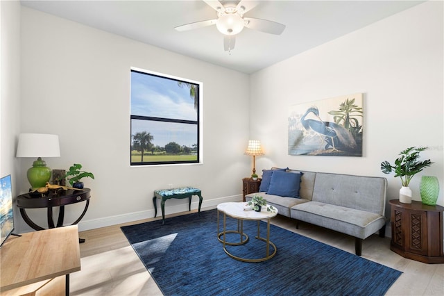 living room with light hardwood / wood-style flooring and ceiling fan