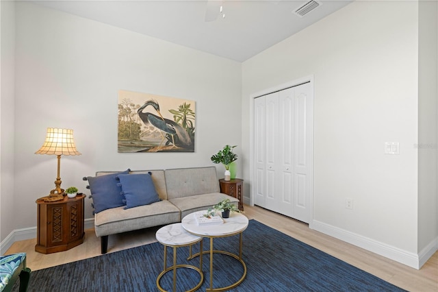 living room featuring ceiling fan and wood-type flooring