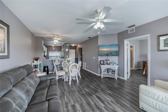 living room with dark hardwood / wood-style floors and ceiling fan