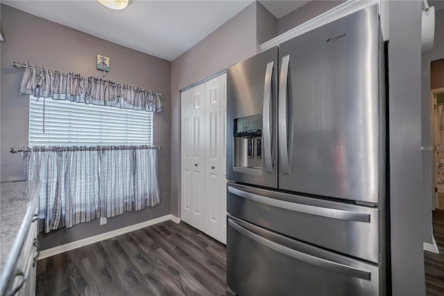 kitchen with stainless steel fridge and dark wood-type flooring