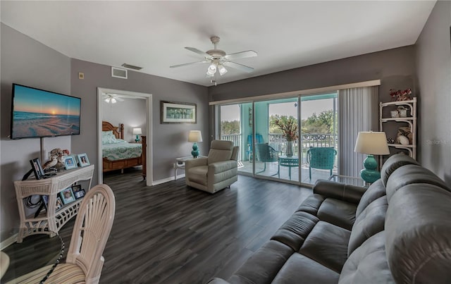 living room featuring ceiling fan and dark hardwood / wood-style flooring