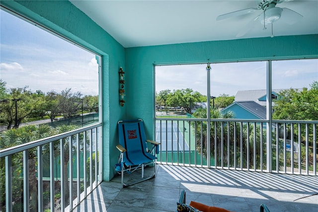 sunroom / solarium featuring plenty of natural light and ceiling fan