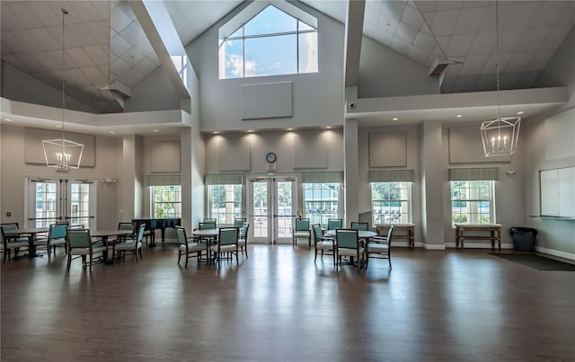 dining area featuring a healthy amount of sunlight, high vaulted ceiling, and french doors