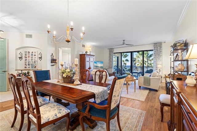 dining area featuring crown molding, light hardwood / wood-style floors, and ceiling fan with notable chandelier