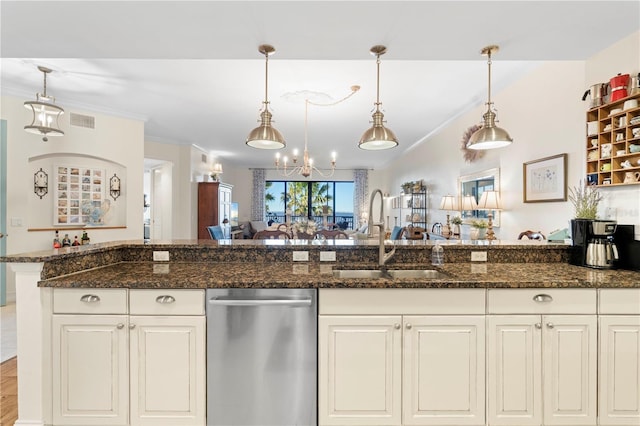 kitchen with white cabinetry, sink, hanging light fixtures, stainless steel dishwasher, and dark stone countertops