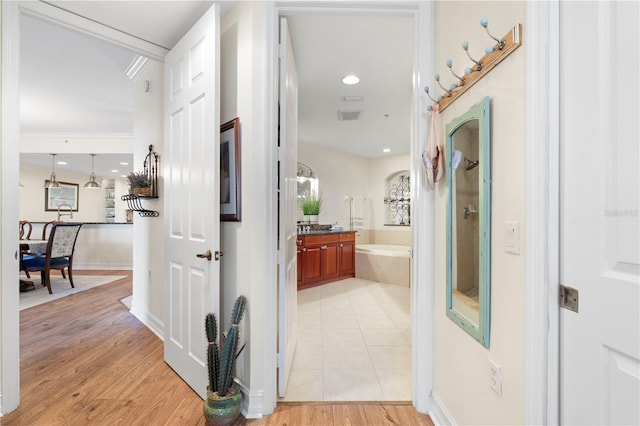 hallway with light hardwood / wood-style floors