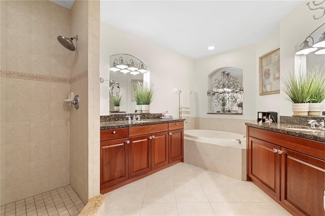 bathroom with plus walk in shower, vanity, and tile patterned flooring