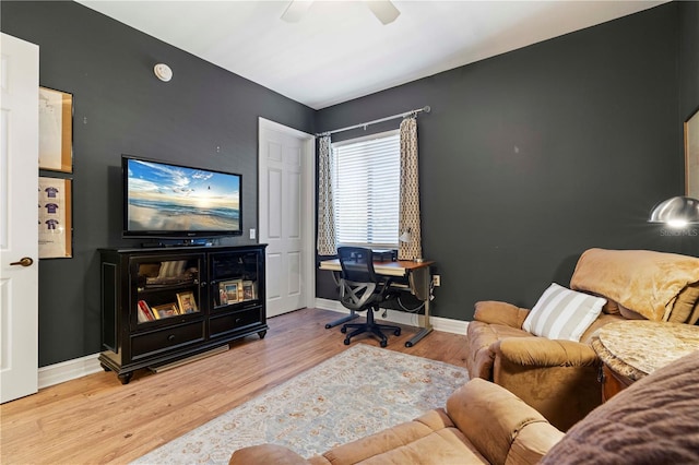 living room featuring hardwood / wood-style floors and ceiling fan