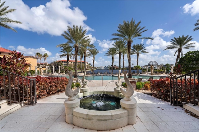 exterior space featuring a jacuzzi and pool water feature