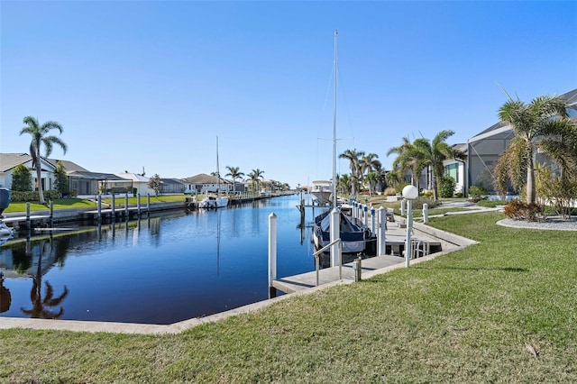 view of dock with a yard and a water view