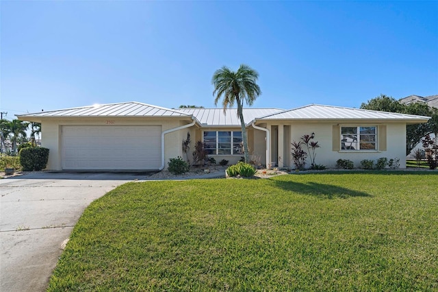 ranch-style house with a garage and a front lawn