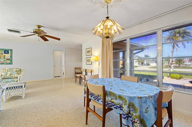 dining area with ceiling fan with notable chandelier