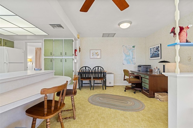 home office with light carpet and ceiling fan