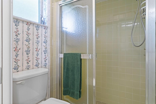 bathroom with toilet and an enclosed shower