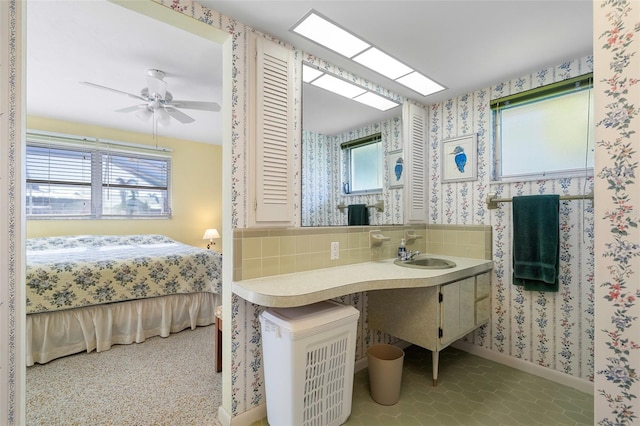 bathroom with decorative backsplash, ceiling fan, and vanity