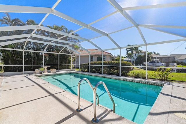 view of pool featuring glass enclosure and a patio area