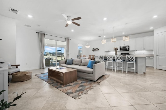 living room with ceiling fan and light tile patterned floors