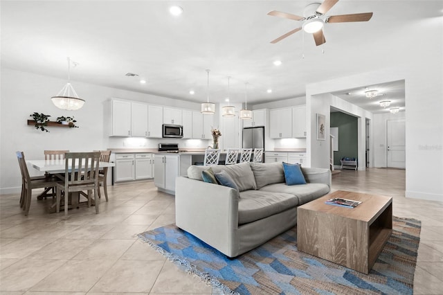 tiled living room with ceiling fan