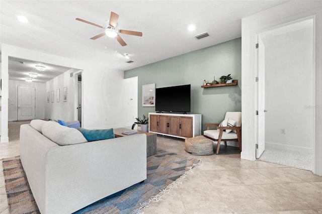 tiled living room featuring ceiling fan