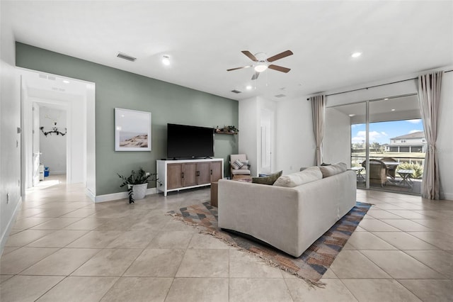 living room featuring ceiling fan and light tile patterned floors