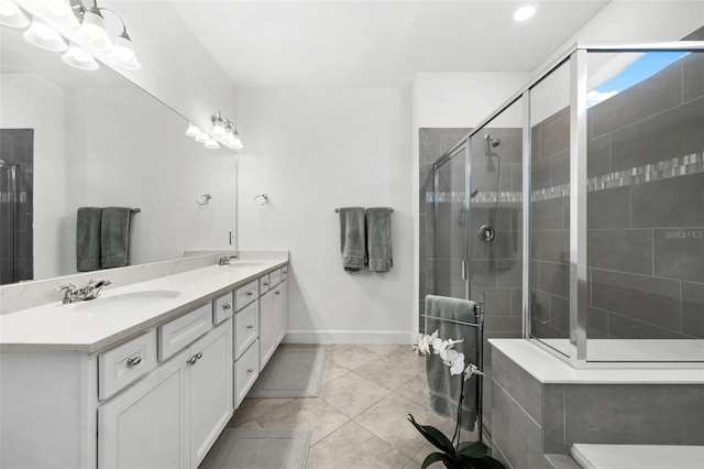 bathroom featuring tile patterned floors, a shower with door, and vanity