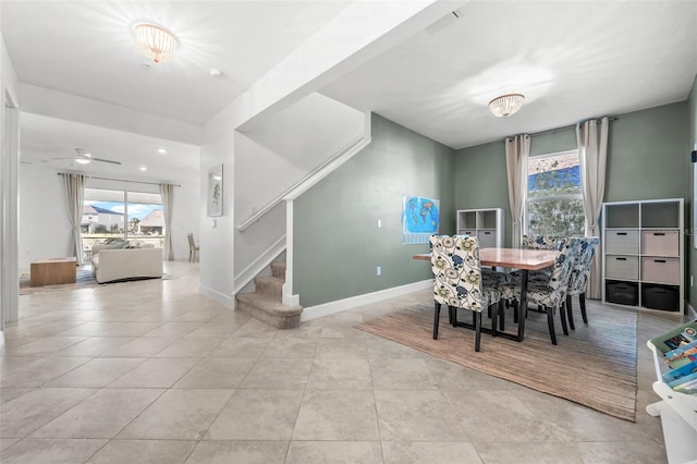 dining space featuring ceiling fan and light tile patterned floors