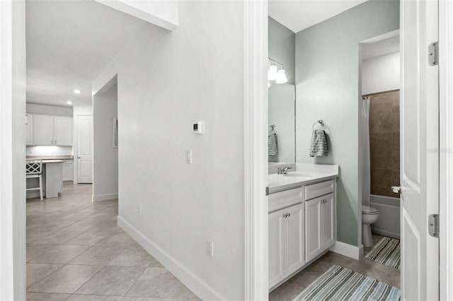 full bathroom with tile patterned flooring, vanity, toilet, and tiled shower / bath