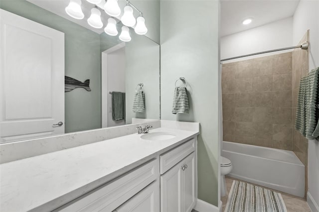 full bathroom featuring tile patterned floors, tiled shower / bath combo, toilet, and vanity