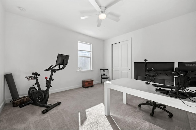 carpeted home office featuring ceiling fan