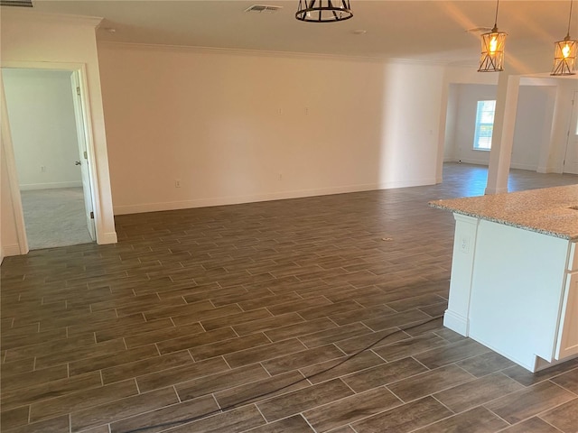 interior space featuring ornamental molding and dark wood-type flooring