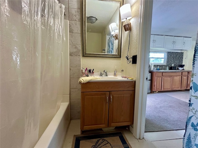 bathroom with tile patterned flooring, vanity, and shower / bathtub combination with curtain