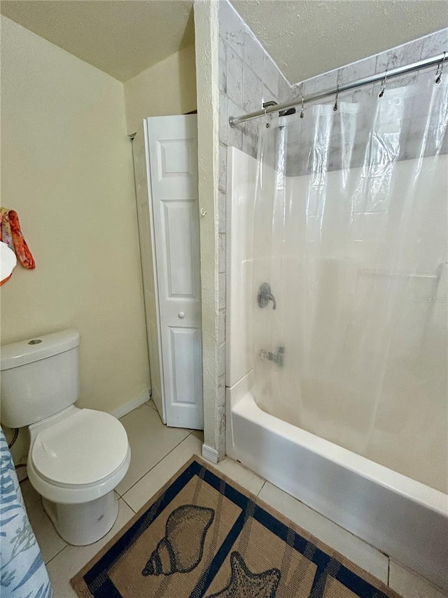 bathroom featuring tile patterned flooring, a textured ceiling, toilet, and shower / bath combo