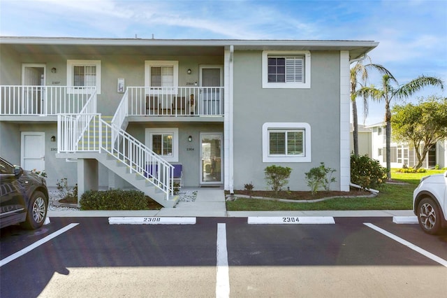 3310 Loveland Blvd Unit 2304, Punta Gorda, FL 33980 - view of building exterior with stairway and uncovered parking