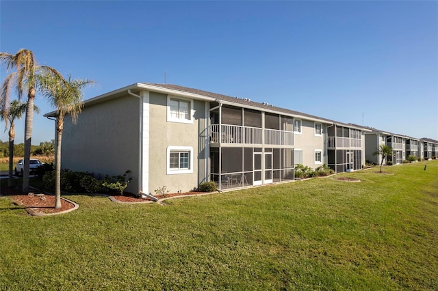 rear view of property with a lawn