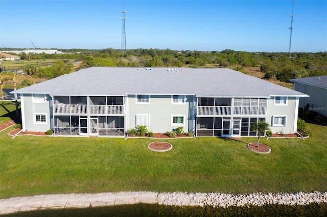 rear view of property featuring a lawn