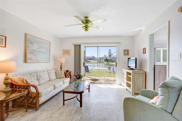 living room with ceiling fan and light wood-type flooring