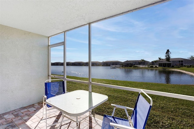 unfurnished sunroom with a water view