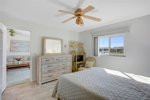 bedroom with ceiling fan and light hardwood / wood-style floors