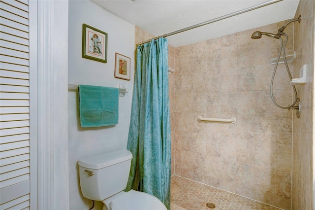 bathroom with a shower with curtain and toilet