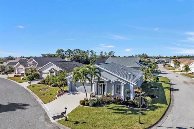 view of front of home with solar panels, a garage, and a front lawn