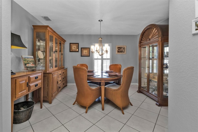 tiled dining space with a notable chandelier